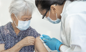 healthcare working giving Covid vaccine