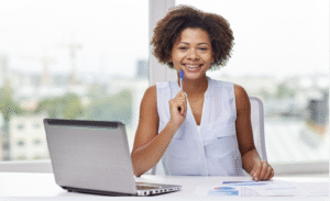 marketing event planner establishing SMART event goals at her laptop