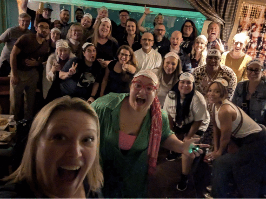 Attendees in pajamas gathered in a conference room at 2 AM during IMEX 2024 to watch the Tropicana Hotel implode — a quirky, intimate event that created lasting connections and exemplified the power of small events vs large events.