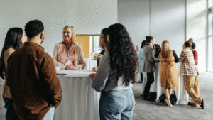 professionals standing at round tables at an event