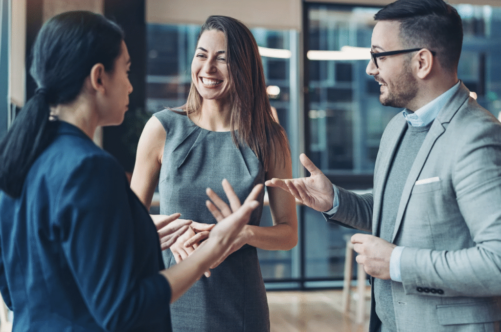 6 Interactive Strategies to Improve Event ROI 2 Event professionals networking and collaborating during a business event, illustrating attendee engagement and interactive event ideas that improve event ROI through connection and participation.