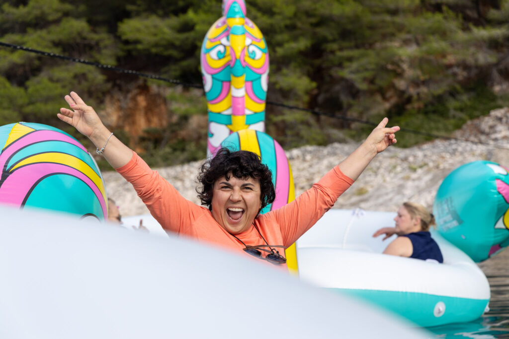 10 Proven Event Marketing Tactics to Generate Qualified Leads 1 A photo of an interactive event marketing tactic: an attendee floats on an inflatable unicorn during a session.